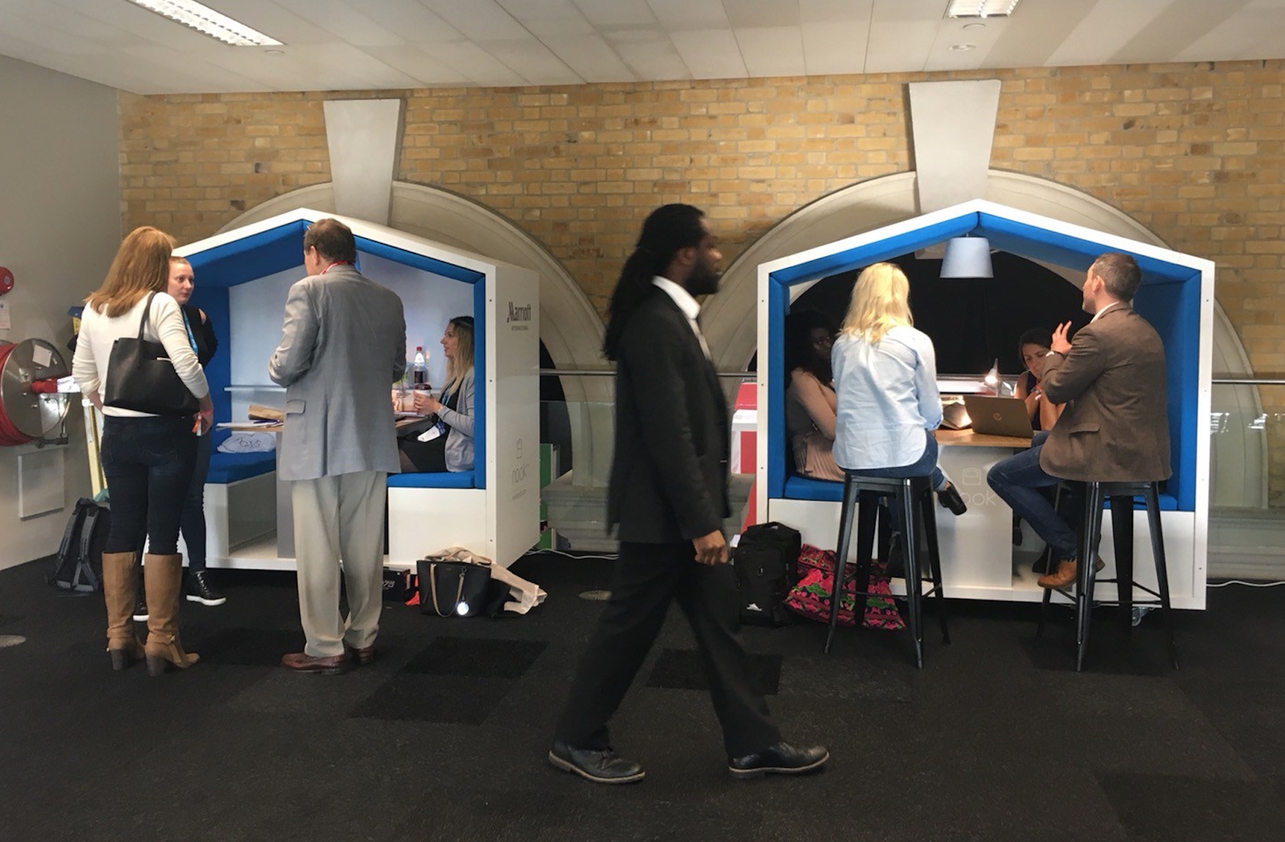 Two Nook Mobile Office Pods with people walking by