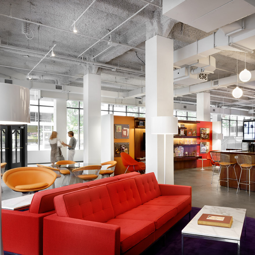 two Florence Knoll Sofas fabric upholstery red in showroom with 