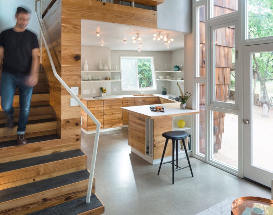 Hive Guesthouse view of kitchen and stairs with man coming down stairs