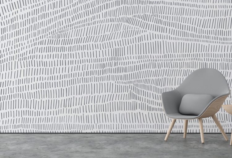 wall with designer walcovering in white with gray multi-directional lines resembling landscape