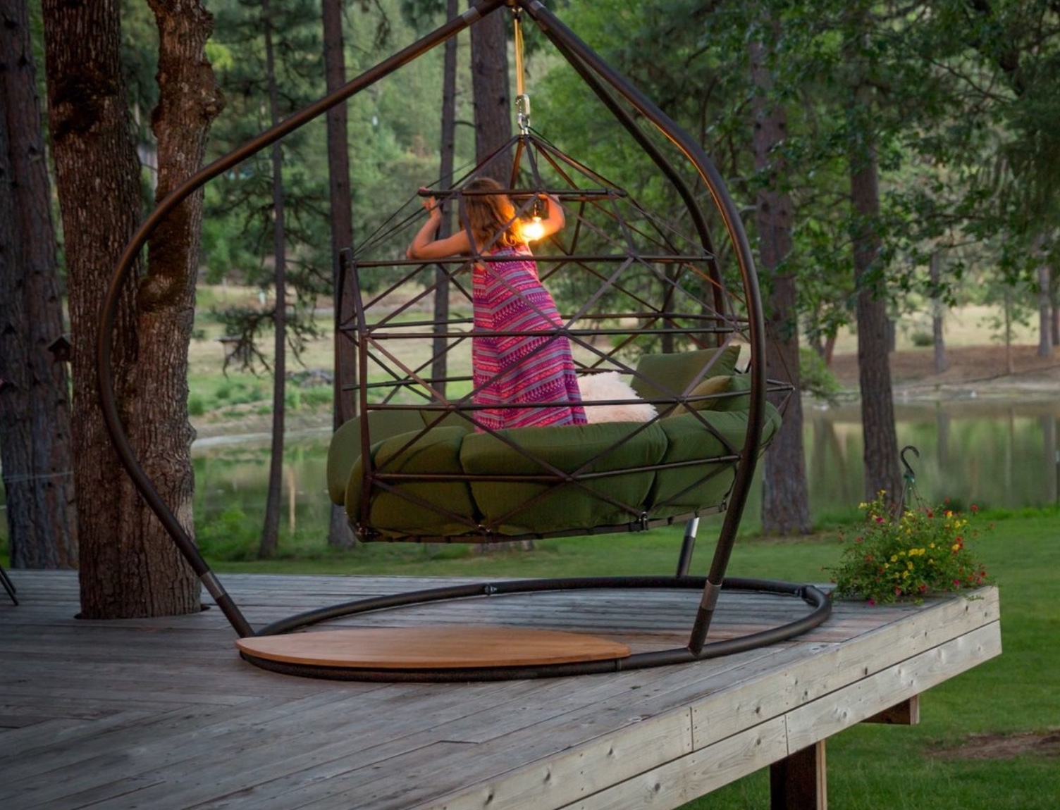 Large Zome outdoors with green cushions and girl standing inside