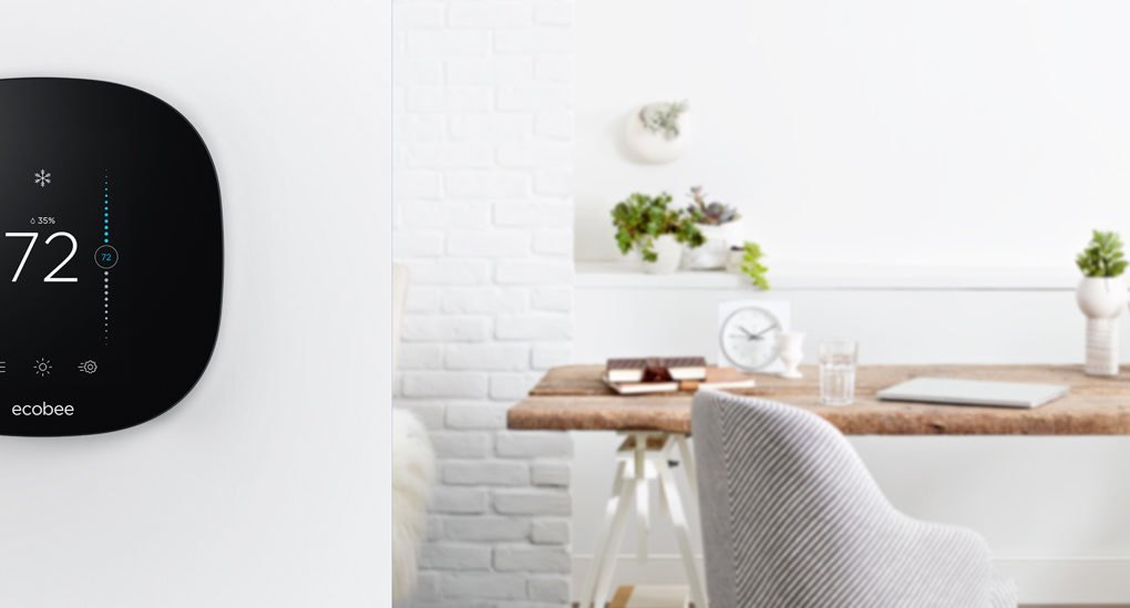ecobee smart thermostat on wall with kitchen in background
