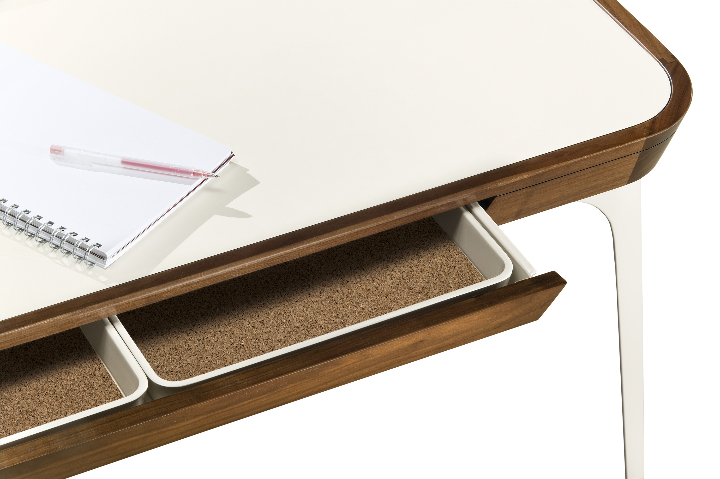 detailed view of white and wood desk with slim open drawers