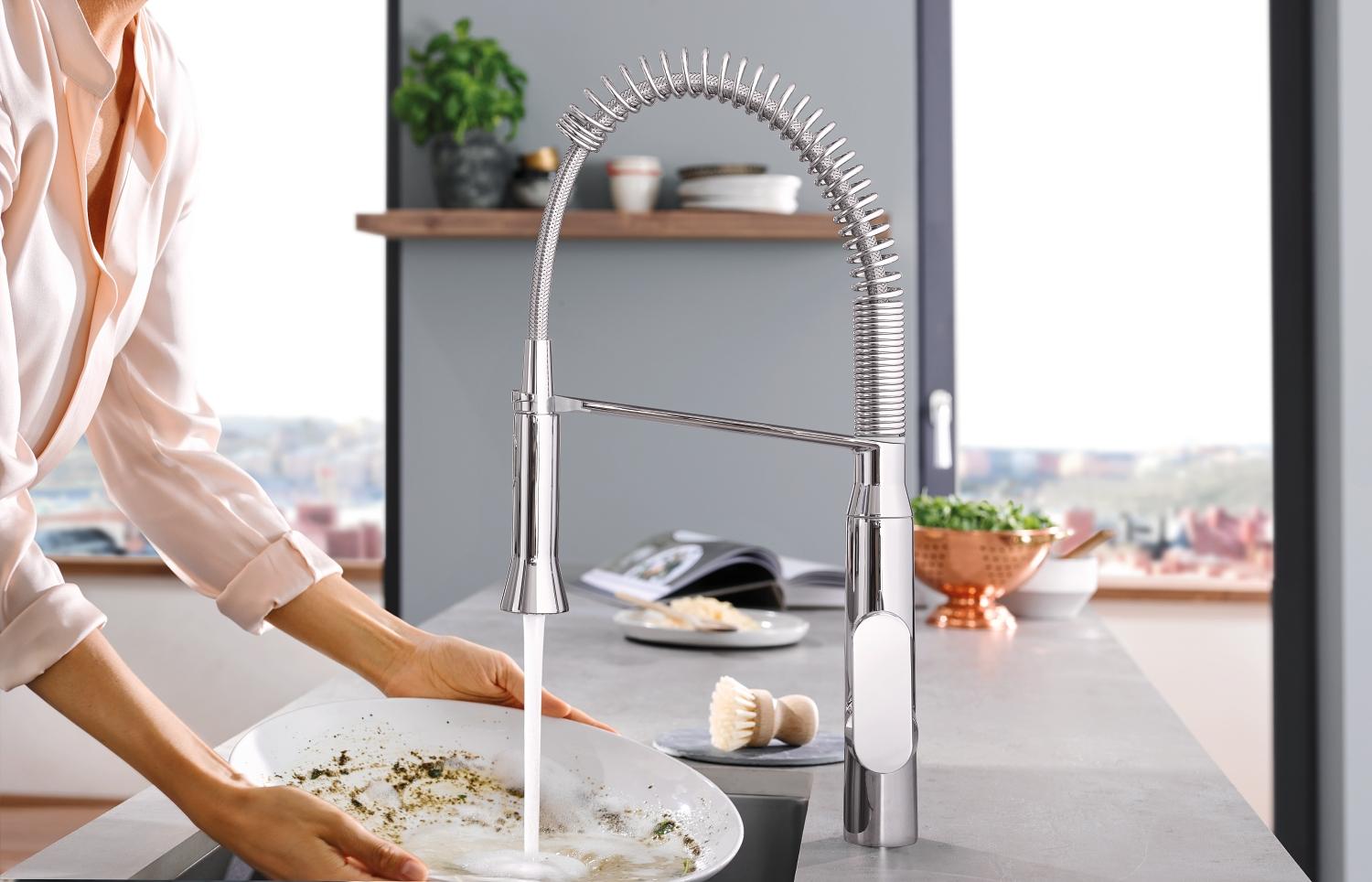 Grohe Faucet Foot Control view of faucet and woman washing dish