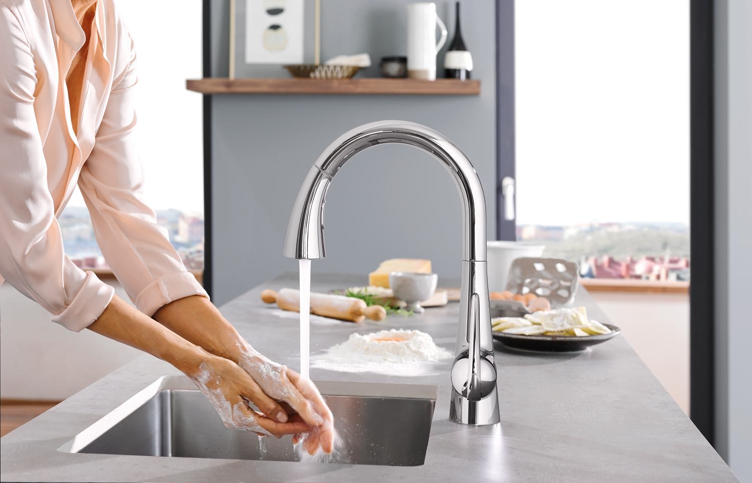 Grohe Faucet Foot Control view of faucet with woman washing hands