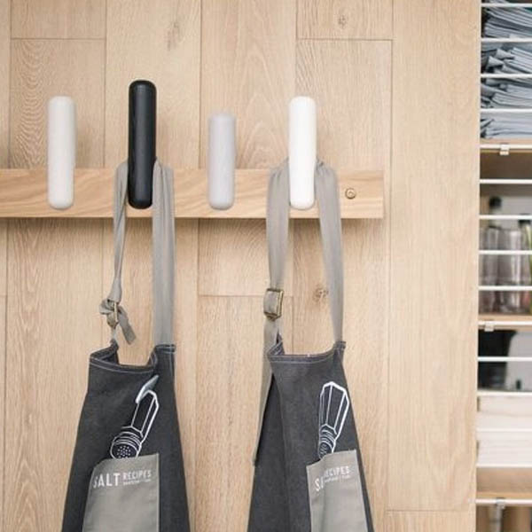 oak coat rack holding aprons