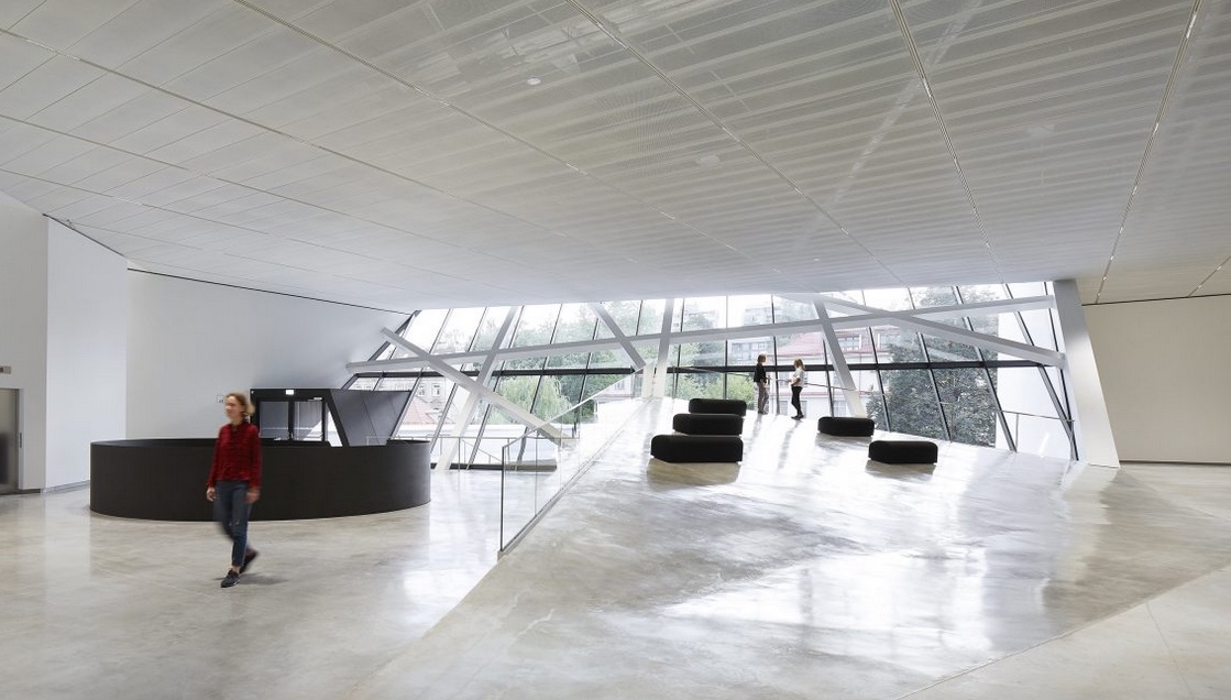 interior of modern museum with white walls and big windows