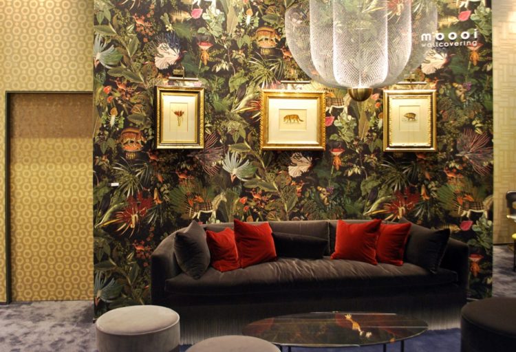 living room with velvet couch and flora and fauna wallpaper