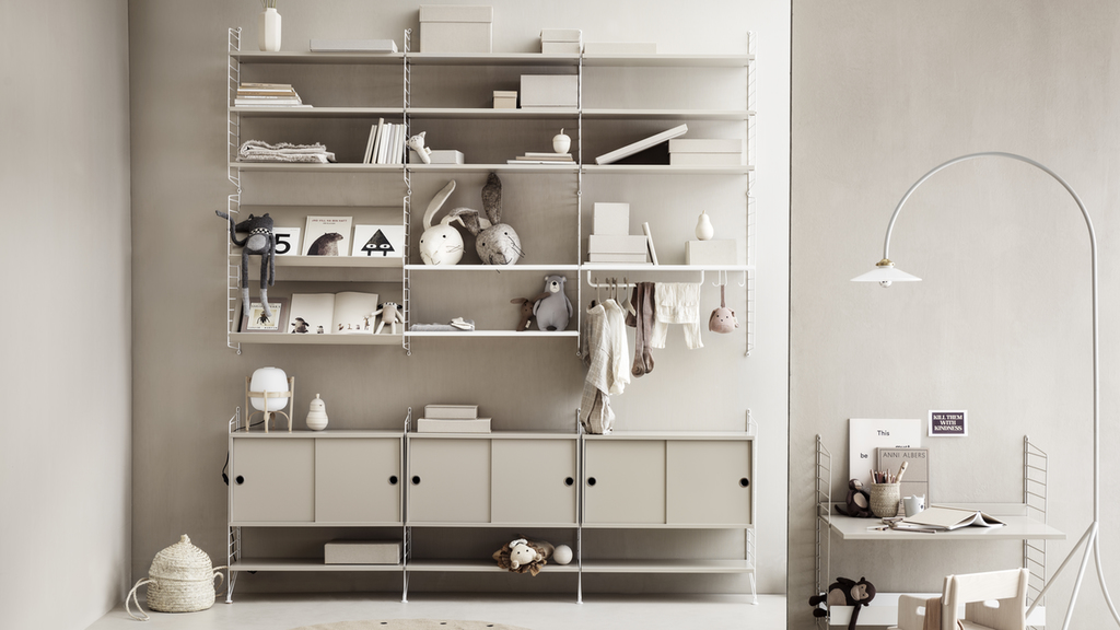 minimalistic kids room with metal shelving system on the wall