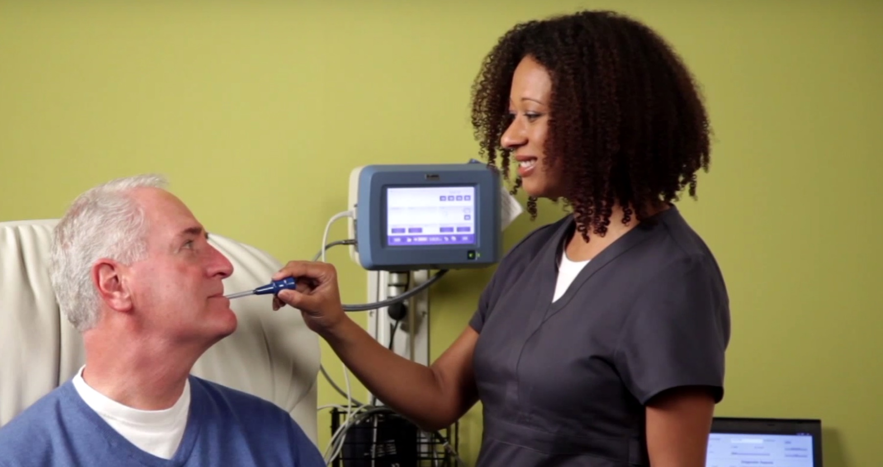 Midmark's IQvitals Nurse and patient taking temperature