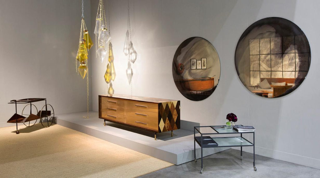 exhibit space with wood sideboard, chandelier, and mirrors