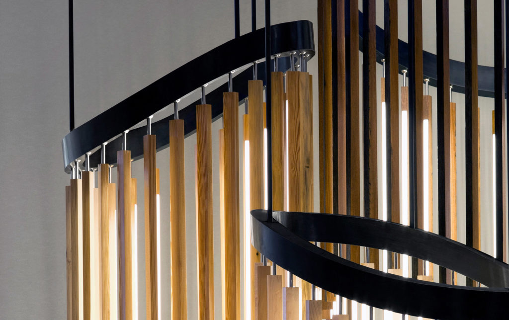 Stickbulb's Chime Chandelier close up of three chandeliers in light wood