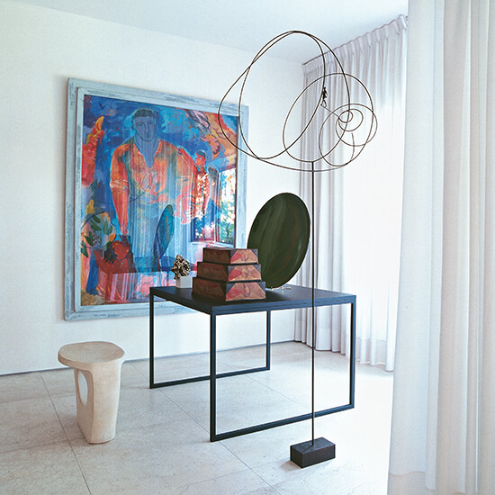 simple square metal desk in white room with modern art