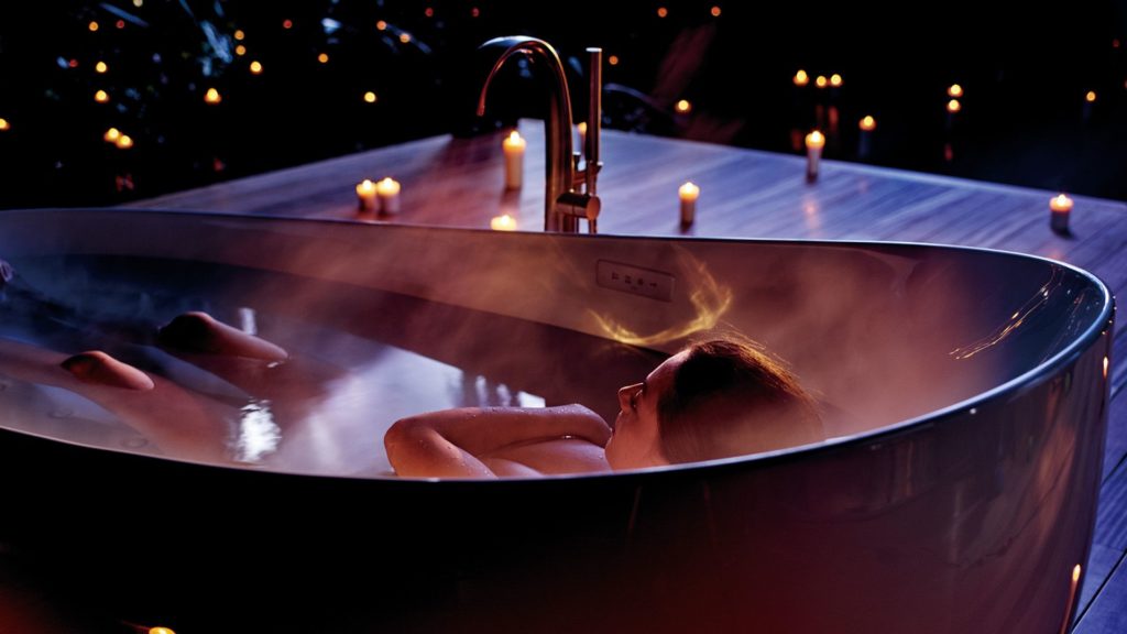 Toto's Zero Dimension woman in tub outdoors on patio