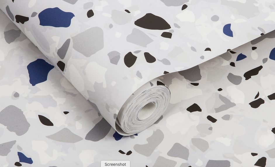 close-up view of wallpaper roll with terrazzo pattern and blue accents