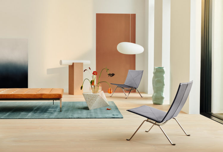 Fritz Hansen PK22 lounge chair in smoke grey two chairs in living room