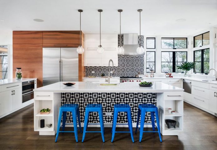 modern white kitchen with black and white geometric tiles on kitchen island and backsplash