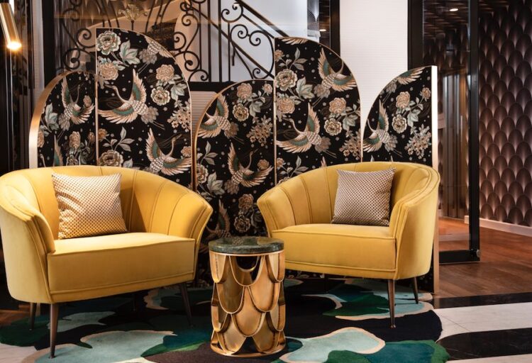 Art Deco boutique hotel lobby with velvet armchairs and mirrors
