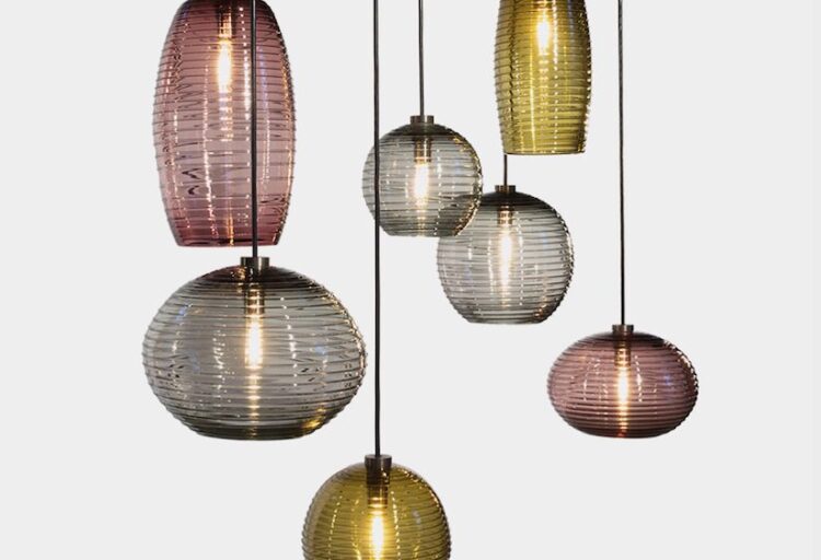 seven handblown glass pendants in amber, plum, and gray glass