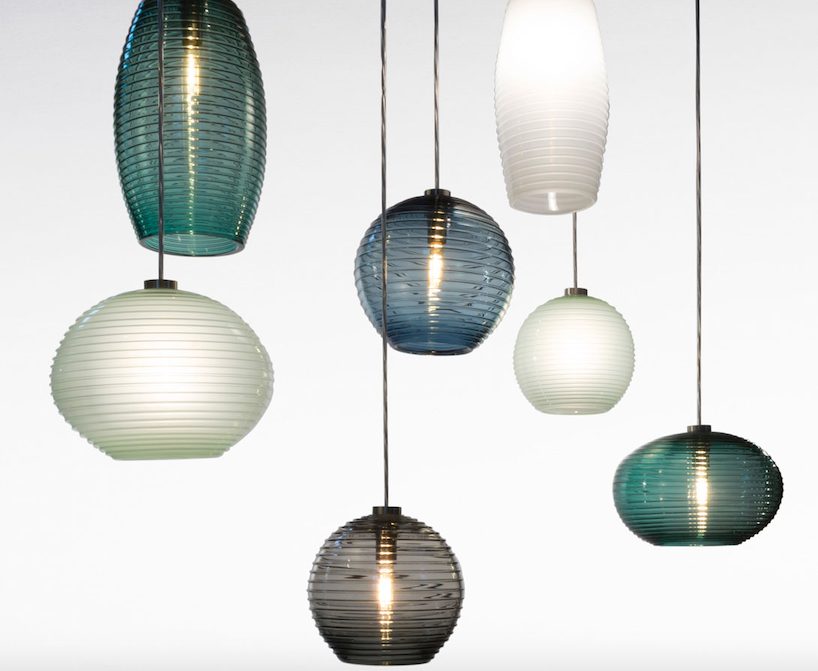 seven handblown glass pendants in shades of blue and white sea glass