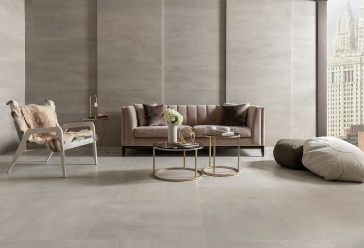 modern living room with large-format wall and floor tiles in neutral earth tones with stone veining