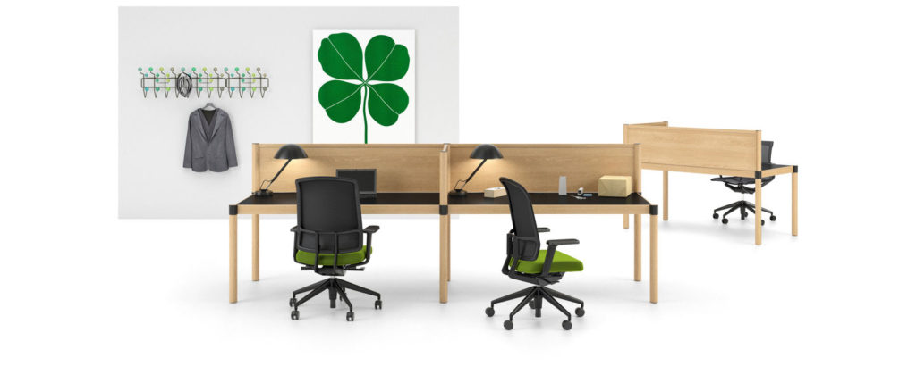 two Vitra Cyl Focus Benches in light wood with dark worktop and task chairs with green upholstered seat cushion