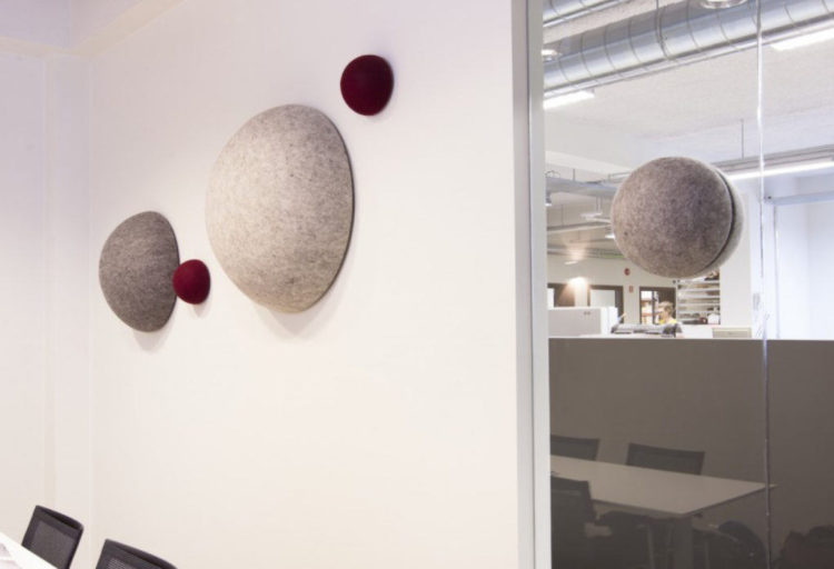 Unika Vaev Kula five units of different sizes in white, gray, red four on white wall and one on glass partition