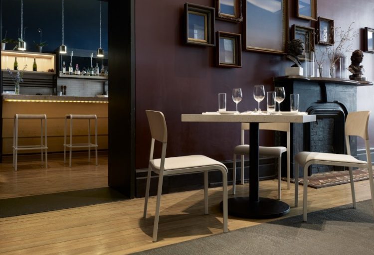 Source International Viiva seating two chairs in bar all white with table and wine glasses
