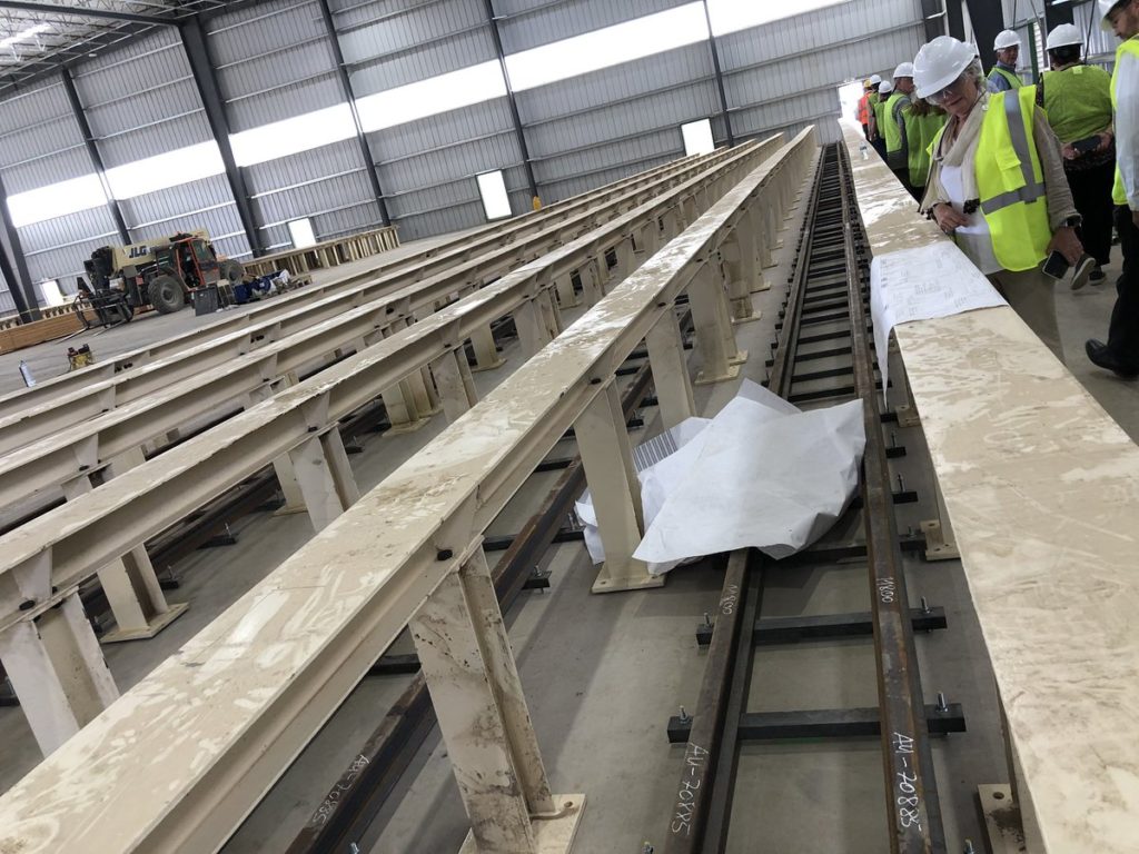 CalPlant Rice-Straw MDF image of production line with workers overseeing 