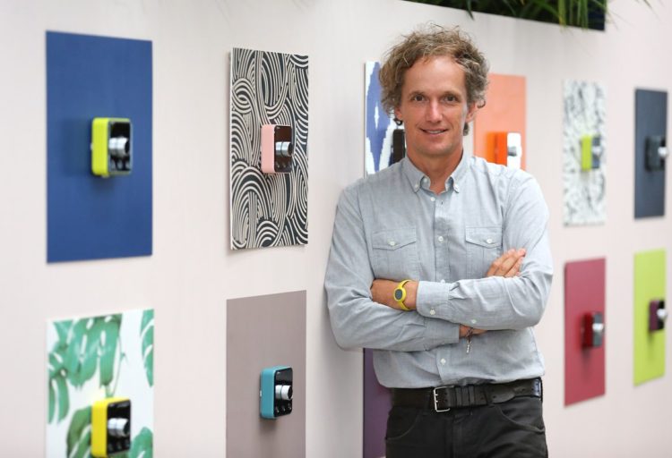 Yvés Behar leaning against wall with many Hive Thermostats