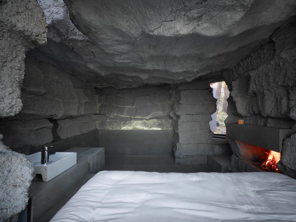 Truffle House interior with bed, basin, and fireplace