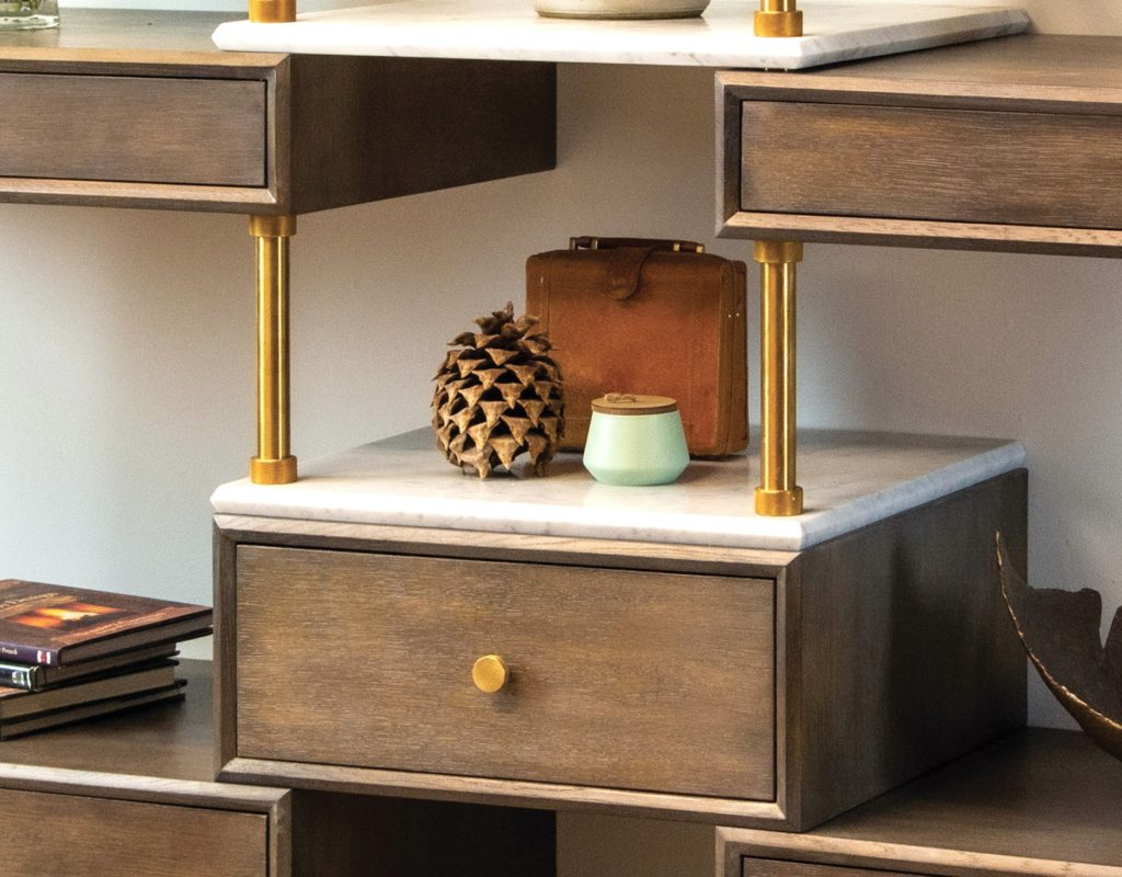Stone Forest Wall Etagere close-up of wood drawers, stone shelf, and brass legs