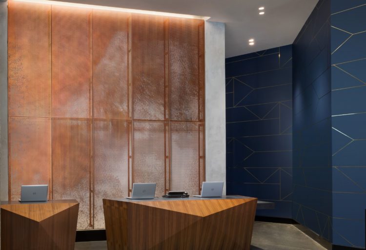 Móz Backlit Metal Solutions perforated screen in sand color in business center of hotel
