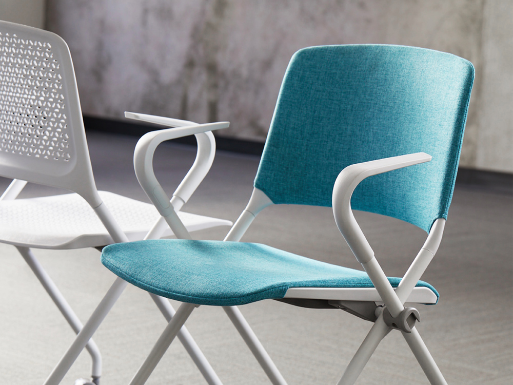 SitOnIt Qwiz Chair two chairs facing opposite directions one with blue upholstered seat and back, the other with white upholstered seat and white mesh back