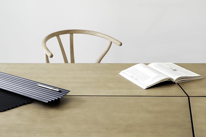 Woodendot's Savia Table partial view of table with open book on it