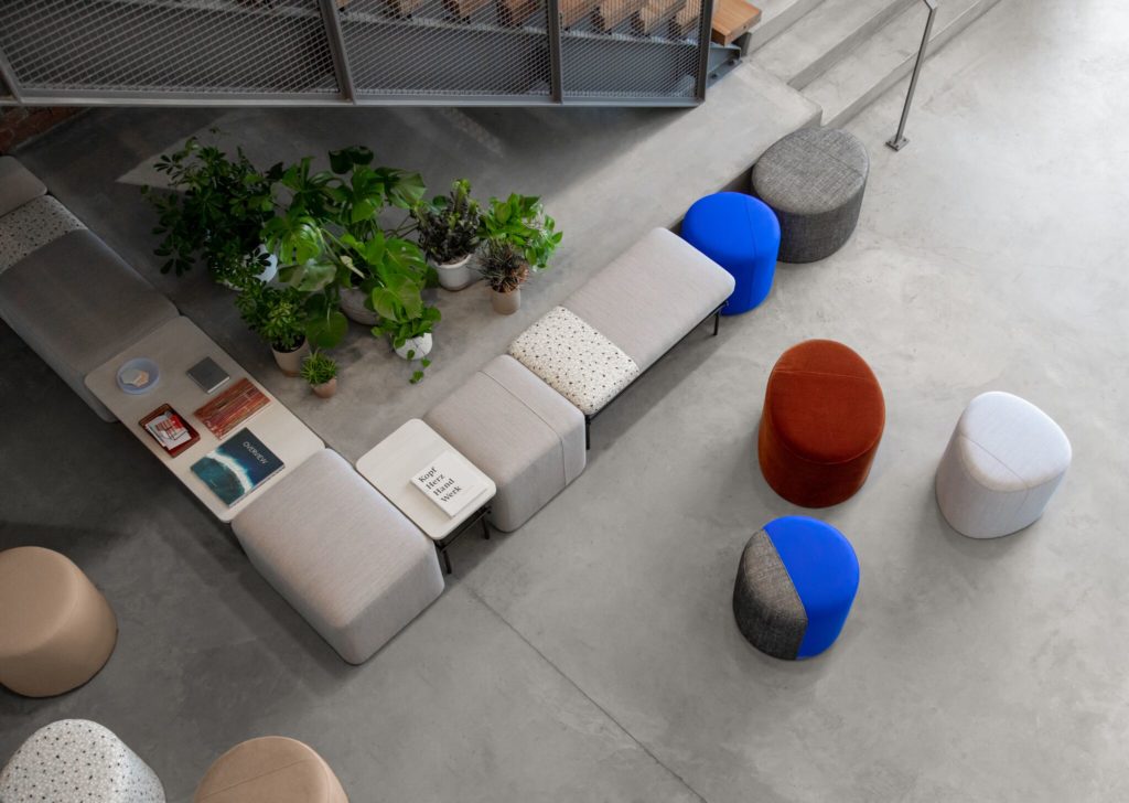 Allsteel Two-Thirds overhead view of many round poufs and square poufs in linear configuration with tables