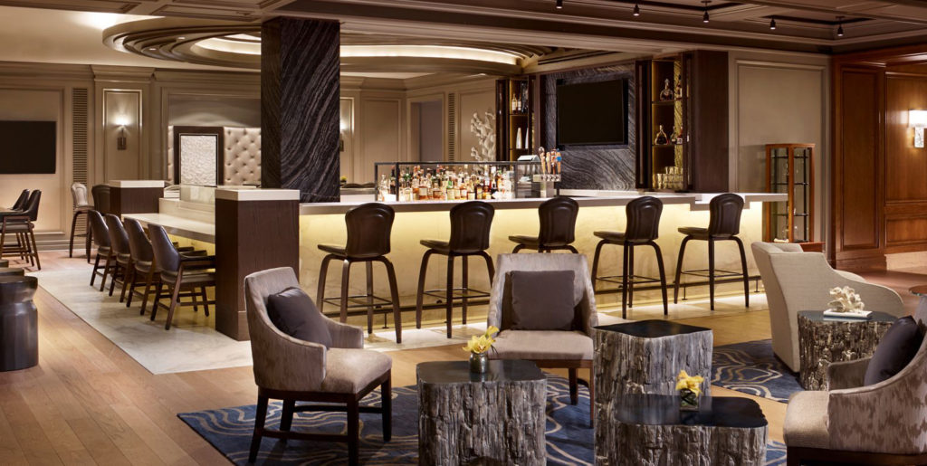 Demar Leather Ritz Carlton South Beach bar and lounge area with many chairs in a neutral palette 