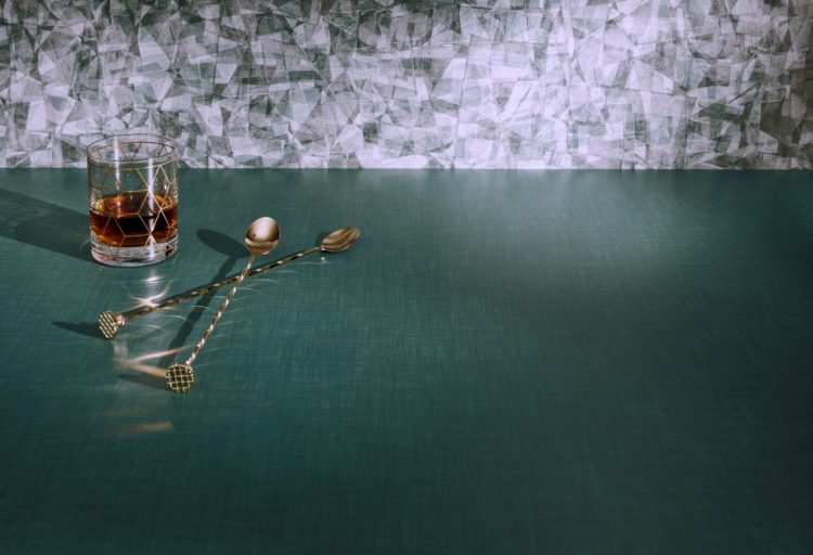 Wilsonart Color Me Intrigued Green Tourmaline with glass of whiskey and stirring spoon