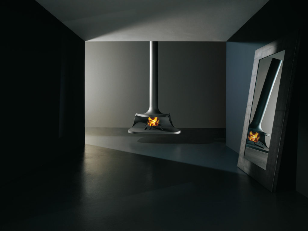 Iosa Ghini Drop Fireplace suspended wood burning fireplace in sleek black metal in middle of dark room