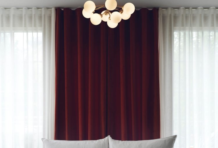 Nuura Apiales 9 Chandelier with backdrop of dark curtains above bed