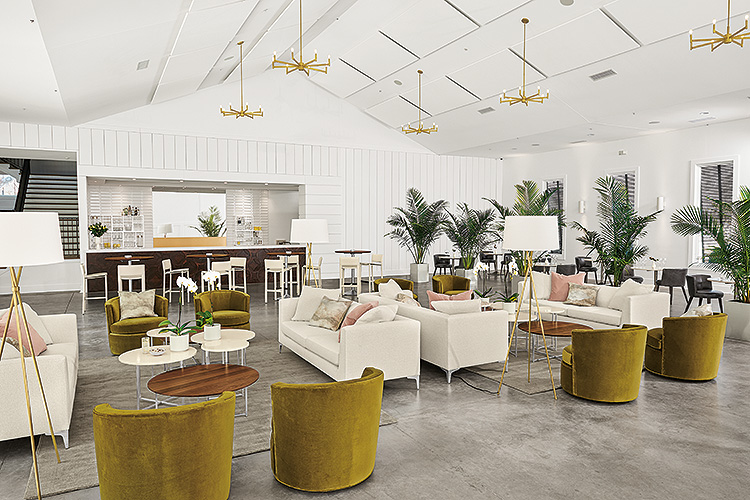 Room & Board Business Interiors green suede chairs, white fabric sofas and white/wood low tables in workspace breakout room