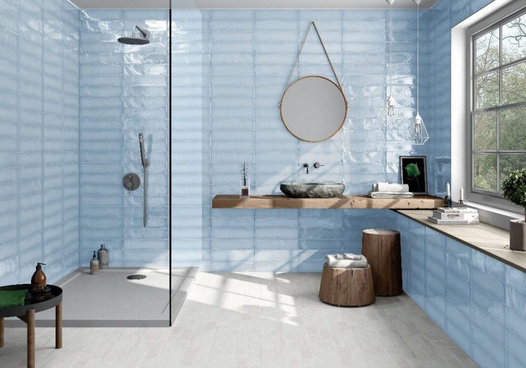 Tile of Spain 2020 designs bathroom with blue translucent tile on walls and in shower