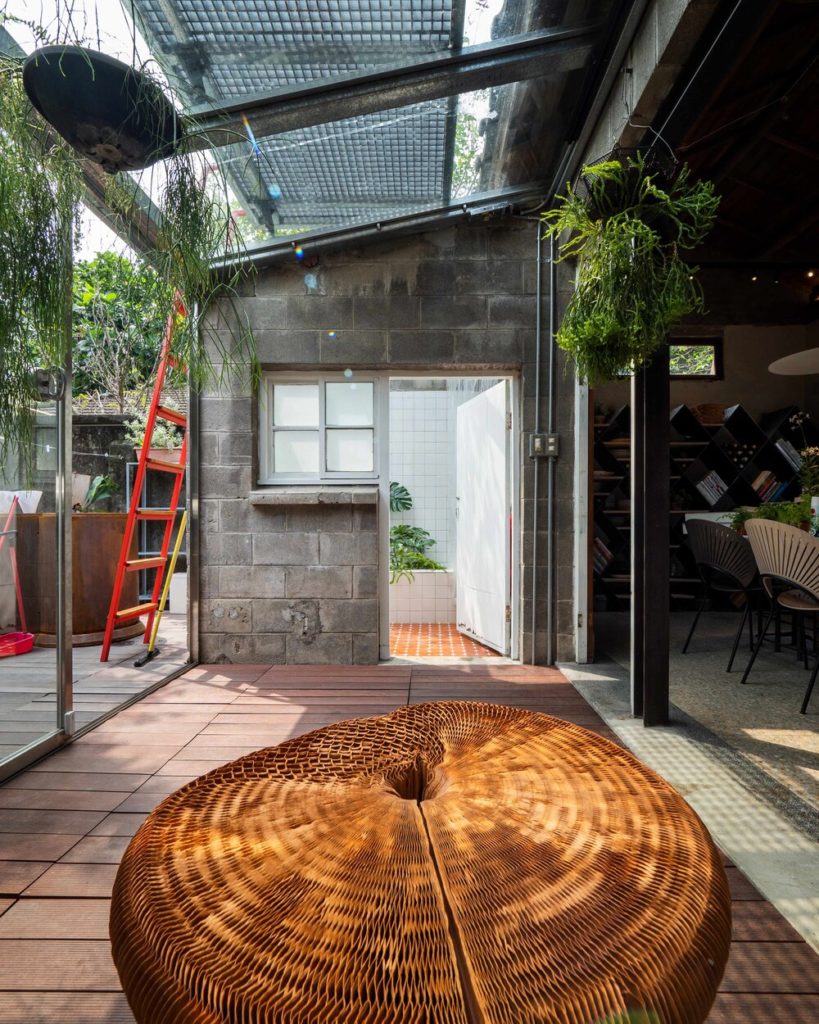 Living Lab glass-enclosed patio with views of garden and red ladder and partial view of home interior
