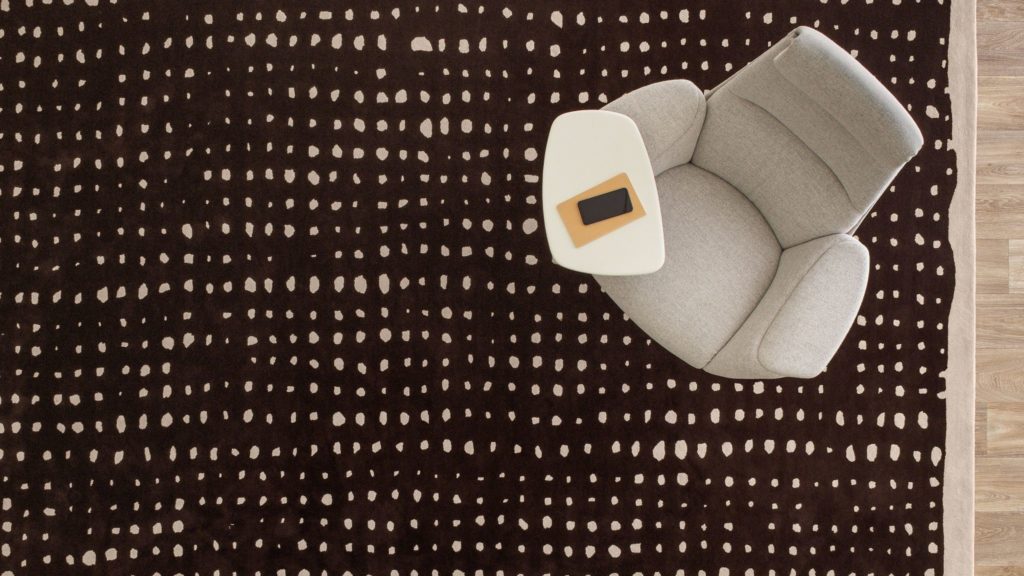 Nanimarquina Collection for Coalesse overhead view of Basket style black with white border and white circles and light gray chair