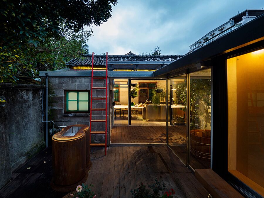 Living Lab exterior back with courtyard showing access to house and red ladder to roof