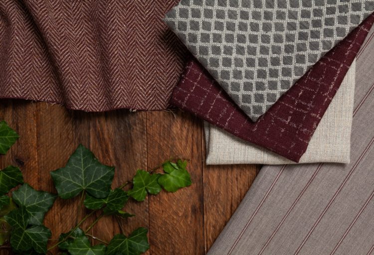 Architex Late Fall Collection Radcliffe Collection detail of five fabrics on table with holly sprig