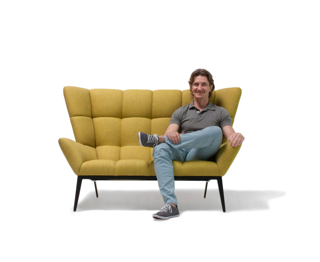 Vioski Tuulla Loveseat mustard with man sitting in it