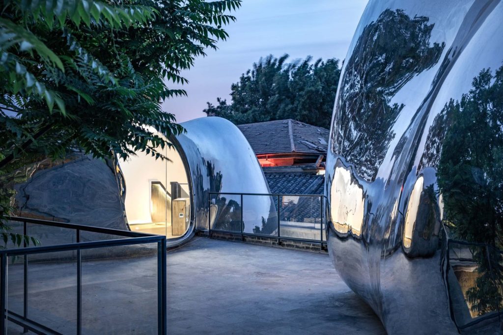 MAD Hutong Bubble 218 view from rooftop next to one bubble looking across at the other with partial interior view