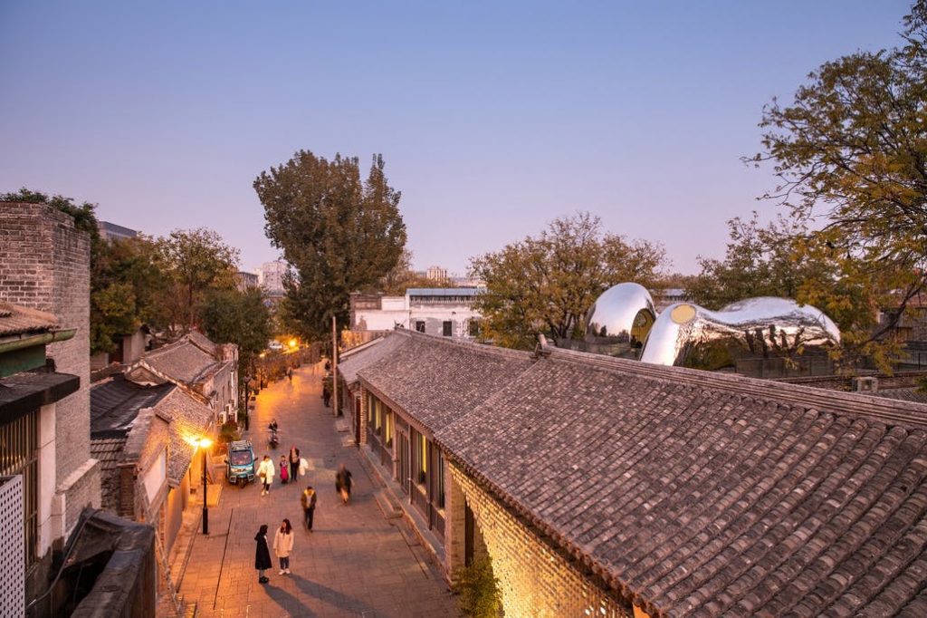 MAD Hutong Bubble 218 view of street with bubbles in the distance and front of structure visible