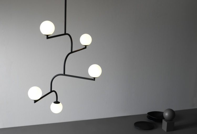 Mobil 100 Pendant black with five diffusers in room with gray wall and dark gray floor